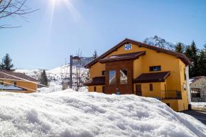 a pile of snow in front of a house at Complejo Hotelero La Braña in San Isidro