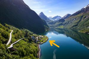 an aerial view of a mountain lake with a yellow arrow at Geirangerfjorden Feriesenter in Geiranger