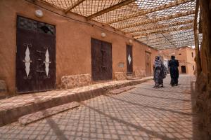 two people walking down a street in a building at Dar Kamar in Ouarzazate