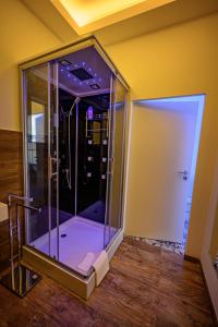 a glass shower in a room with a wooden floor at Little Suite in Halle an der Saale +46 photos