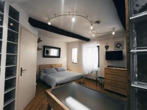 a bedroom with a bed and a tub in it at L'Angelo pellegrino miniappartamenti in Rieti