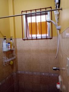 a shower with a window in a bathroom at Violin Mountain in Dumaguete