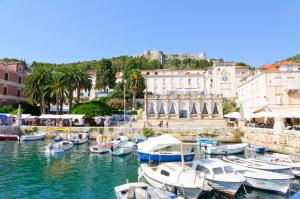 a group of boats docked in a harbor with buildings at Studio Apartment Hvar (221-1) in Hvar