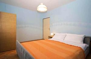 una camera con un letto arancione e bianco di Apartment Sveti Petar Biograd a Sveti Petar