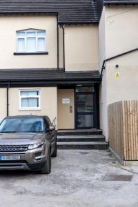 a car parked in front of a house at 2C SPV Double En-suite Room in Wakefield