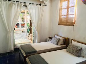 two beds in a room with a window at Mill.Space in Carboneras +62 photos