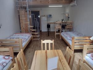 a room with four bunk beds and a table and chairs at Pension Fontána Svitavy in Svitavy