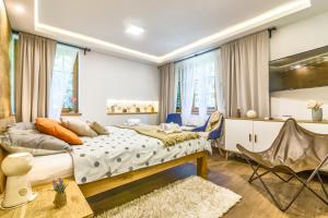 a bedroom with a bed and a table and chairs at B&B Plitvica Creek in Plitvica Selo