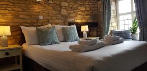a bedroom with a bed with stuffed animals on it at The Kings Arms Hotel in Stow on the Wold