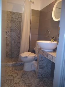 a bathroom with a toilet and a sink at Galanopoulos Hotel in Loutraki