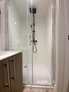 a shower with a glass door in a bathroom at Stansted Airport Luxury Apartment Bishops Stortford Millars One Loft 2 in Bishops Stortford