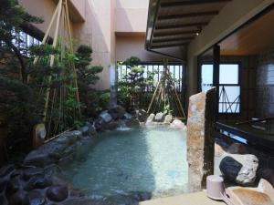 a swimming pool in the middle of a building at Onyado Nono Kanazawa in Kanazawa