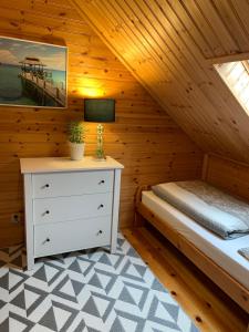 a bedroom with a bed in a wooden cabin at Rewalia in Rewal
