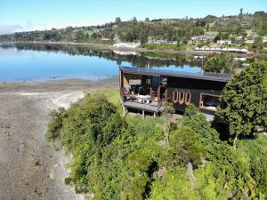 an overhead view of a house on the water at CASA BARCA DE CHILOÉ in Castro