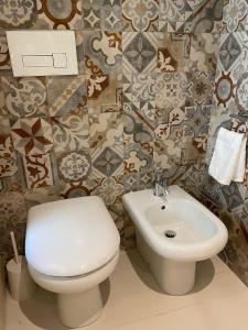 a bathroom with a toilet and a sink at Petra Oikia in Corigliano dʼOtranto