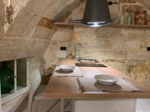 a kitchen with a counter with two bowls on it at Petra Oikia in Corigliano dʼOtranto