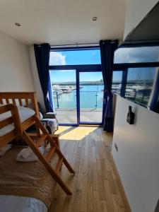 a bedroom with a bed and a view of the ocean at Carlingford Marina Apartments in Carlingford