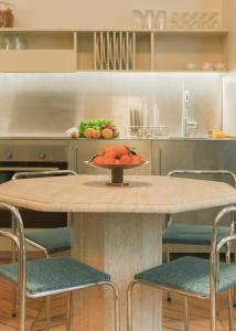 a table with a bowl of fruit on it in a kitchen at Pied A Terre - Palestro in Paris