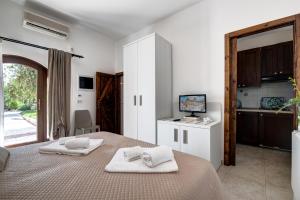 a bedroom with two white towels on a bed at Masseria Valente in Ostuni