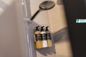 un gruppo di quattro bottiglie su una mensola in bagno di The Riddoch Apartment by The National Trust Scotland a Edimburgo Altre 31 foto