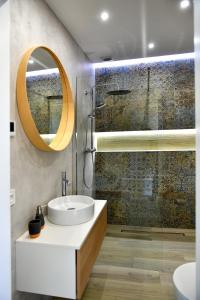 a bathroom with a sink and a mirror at Apartamenty na Dworskiej in Spytkowice