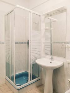 a white bathroom with a sink and a shower at Oriente DNA Studios III in Lisbon