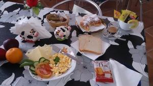 a table with plates of food on a table at Il Mirto E La Rosa in Arenella