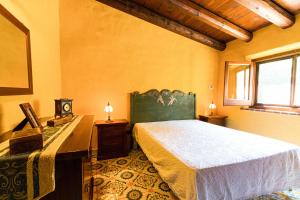 a bedroom with a bed and a table and a window at Villa Fratantoni Piana - Villa privata con accesso diretto alla spiaggia in Caronia Marina