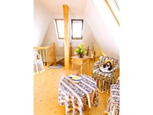 a room with a table and a dog sitting in a chair at Villa Seenland in Böhlen