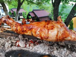 a large turkey is cooking on a grill at Resort Zafaran by H&H in Sarajevo