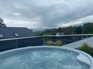 a hot tub on top of a roof with a view at The Tal-Y-Cafn Hotel in Tal-y-Cafn