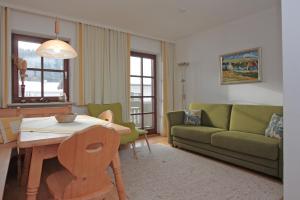 a living room with a couch and a table at Gschwendtnerhof App13 Lincke in Aschau im Chiemgau