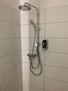 a shower with a shower head in a bathroom at besttime Hotel Monschau in Monschau