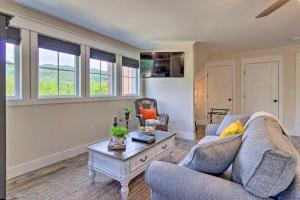 a living room with a couch and a table at Cozy Landrum Escape by Parks, Trails and Lakes! in Landrum