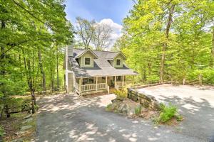 a home in the woods with a driveway at Cozy Retreat with Deck and Sapphire Resort Access! in Sapphire