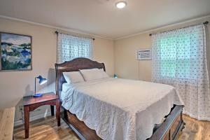 a bedroom with a bed and a table with a lamp at Near Natl Park Hollywood Park Hot Springs Home in Hot Springs