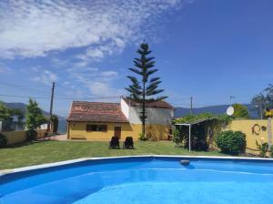 a villa with a pool and a house at CASA O PIÑEIRO in Redondela