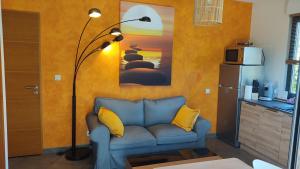 sala de estar con sofá azul y lámpara en coucher de soleil vensac ocean Montalivet, en Vensac