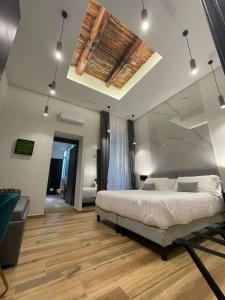 a bedroom with a large bed and a wooden floor at 4heavens_naples in Naples