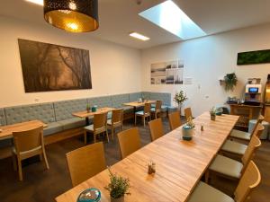 a dining room with wooden tables and chairs at besttime Hotel Monschau in Monschau