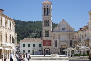 a large building with a clock tower in a town at Old Town Hvar Apartment in Hvar