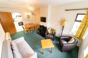 a living room with a couch and chairs and a table at Crescent Close in Galway