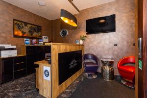 a waiting room with a desk and two chairs at Hotel Meduza in Senj