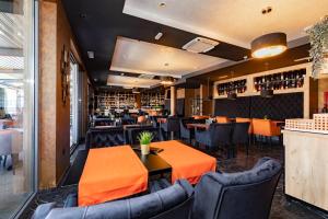 a dining room with tables and chairs in a restaurant at Hotel Meduza in Senj