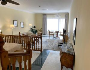 a bedroom with a bed and a living room at Los Cinco Enebros in Robledo de Chavela