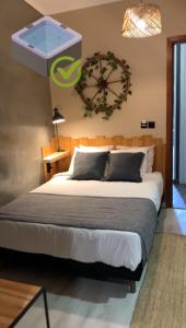 a bedroom with a large bed with a clock on the wall at Casa Do Campo in Peniche