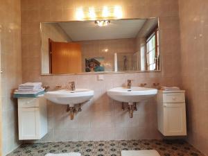 a bathroom with two sinks and a mirror at Haus Annaburg in Mariazell