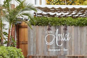 a fence with a cafe united sign on it at Sonder Beverly Terrace in Los Angeles