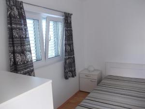 a bedroom with a bed and a window at Apartment Hvar Bike in Stari Grad