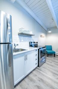 a kitchen with a stainless steel refrigerator and a sink at Boutique Suite #6 in Blue Mountains